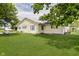 Charming single-story home with yellow siding, surrounded by lush green lawn and mature trees at 3642 S Mauxferry Rd, Franklin, IN 46131