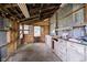 Interior of a workshop featuring built-in cabinets, work surfaces, and natural light from a window at 3642 S Mauxferry Rd, Franklin, IN 46131