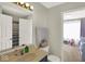Bathroom features a vanity and view into an adjacent room with window at 3832 Boundary Bay Dr, Indianapolis, IN 46217