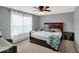 Well-lit bedroom with a large window, a ceiling fan, and a dark wood bed creates a cozy ambiance at 3832 Boundary Bay Dr, Indianapolis, IN 46217