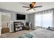 Comfortable bedroom with a ceiling fan, a TV, and a chair offers a relaxing space at 3832 Boundary Bay Dr, Indianapolis, IN 46217