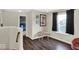 Upper bonus room with dark wood floors, a window, and a small table provides flexible space at 3832 Boundary Bay Dr, Indianapolis, IN 46217
