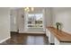Bright dining area with a light fixture, white curtains, and long butcher block countertop with dark wood floors at 3832 Boundary Bay Dr, Indianapolis, IN 46217