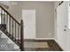 Foyer featuring a staircase with carpeted treads, an exterior door, and dark wood-look flooring at 3832 Boundary Bay Dr, Indianapolis, IN 46217