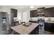 Modern kitchen featuring stainless steel appliances, dark cabinets, and an island perfect for food preparation at 3832 Boundary Bay Dr, Indianapolis, IN 46217