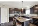 Bright kitchen featuring stainless steel appliances, dark cabinets, and an island with barstool seating at 3832 Boundary Bay Dr, Indianapolis, IN 46217