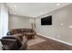 Living room showcasing wood floors, a dark brown leather sofa and accent chair at 3832 Boundary Bay Dr, Indianapolis, IN 46217