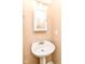 Cozy bathroom features a pedestal sink and classic fixtures, a simple and practical space at 3839 Churchman Woods Blvd, Indianapolis, IN 46203