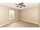 Bedroom featuring a ceiling fan, neutral walls, carpeted floors, and a bright window at 3839 Churchman Woods Blvd, Indianapolis, IN 46203
