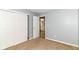 Carpeted bedroom with closet and open door showing view to hallway and staircase at 3839 Churchman Woods Blvd, Indianapolis, IN 46203