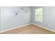 Neutral-toned bedroom with a window and cute animal-themed wall decor at 3839 Churchman Woods Blvd, Indianapolis, IN 46203
