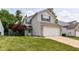 Charming two-story home featuring vinyl siding, brick accents, and an attached two-car garage at 3839 Churchman Woods Blvd, Indianapolis, IN 46203