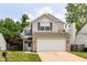 Charming two-story home featuring vinyl siding, brick accents, and an attached two-car garage at 3839 Churchman Woods Blvd, Indianapolis, IN 46203