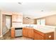 Functional kitchen featuring wooden cabinets and pass-through to living area, creating an inviting space at 3839 Churchman Woods Blvd, Indianapolis, IN 46203