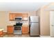 This practical kitchen offers stainless steel appliances and wooden cabinets, ideal for easy meal preparation at 3839 Churchman Woods Blvd, Indianapolis, IN 46203