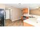 Functional kitchen features neutral tones, tile floor, and appliances, creating an inviting space at 3839 Churchman Woods Blvd, Indianapolis, IN 46203
