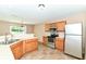 This inviting kitchen provides stainless steel appliances and wooden cabinets, perfect for cooking enjoyment at 3839 Churchman Woods Blvd, Indianapolis, IN 46203