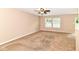 Spacious living room with neutral carpet, fan and plenty of natural light at 3839 Churchman Woods Blvd, Indianapolis, IN 46203