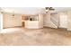 Open-concept living room flows into the kitchen with a breakfast bar and updated appliances at 3839 Churchman Woods Blvd, Indianapolis, IN 46203