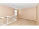 The expansive loft space with neutral carpet provides ample room for recreation or a home office at 3839 Churchman Woods Blvd, Indianapolis, IN 46203