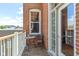 Outdoor balcony with a chair, a small table, and a view of neighboring buildings at 404 E New York E St # 406, Indianapolis, IN 46202