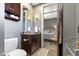 Bathroom featuring a vanity with granite counters, and views into the bedroom at 404 E New York E St # 406, Indianapolis, IN 46202