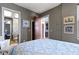Well-lit bedroom showcasing neutral tones, with views into bathroom and kitchen at 404 E New York E St # 406, Indianapolis, IN 46202