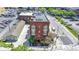 Aerial view capturing the red brick building, adjacent parking, and nearby street with greenery at 404 E New York E St # 406, Indianapolis, IN 46202