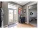 View of hallway with small desk, stainless steel fridge, and access to balcony at 404 E New York E St # 406, Indianapolis, IN 46202