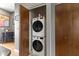 Convenient laundry room featuring a stacked washer and dryer unit for easy access at 404 E New York E St # 406, Indianapolis, IN 46202