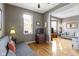 Cozy living space with hardwood floors, a futon, and access to another room at 404 E New York E St # 406, Indianapolis, IN 46202