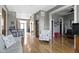 View of a living room with hardwood floors, kitchen bar, and view of a bedroom at 404 E New York E St # 406, Indianapolis, IN 46202