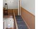 Carpeted staircase with wooden railing and trim providing access to different floors at 404 E New York E St # 406, Indianapolis, IN 46202