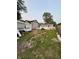 Backyard with overgrown grass, construction debris, detached garage and fence along the perimeter at 4106 N Pasadena Ave, Indianapolis, IN 46226