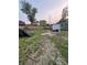 Backyard with a fence, dirt and grass, construction debris, and a partially obscured view of the neighboring homes at 4106 N Pasadena Ave, Indianapolis, IN 46226