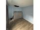 A bedroom in need of repair, features new floors, light blue walls, and awaits your vision at 4106 N Pasadena Ave, Indianapolis, IN 46226