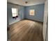 Cozy bedroom features new flooring, two windows for light, and fresh paint at 4106 N Pasadena Ave, Indianapolis, IN 46226