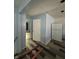 Hallway revealing a door, refrigerator and new floors offering easy access between rooms at 4106 N Pasadena Ave, Indianapolis, IN 46226