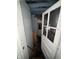 Hallway featuring an open glass paneled door, along with drywall, construction materials, and possible damage at 4106 N Pasadena Ave, Indianapolis, IN 46226