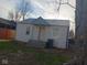 A small house with brick exterior, metal roof, and minimal landscaping at 4106 N Pasadena Ave, Indianapolis, IN 46226