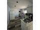 Kitchen featuring stainless steel appliances and new floors awaiting personal touches and finishing at 4106 N Pasadena Ave, Indianapolis, IN 46226
