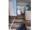 Incomplete room with blue walls, a door, hardwood floors, and a large refrigerator unit at 4106 N Pasadena Ave, Indianapolis, IN 46226