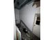 Room features exposed beams, drywall damage, along with loose construction materials, and electrical wiring at 4106 N Pasadena Ave, Indianapolis, IN 46226