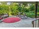 Cozy backyard patio with rocking chairs and a bench surrounded by lush green landscaping at 4163 Otterbein Ave, Indianapolis, IN 46227