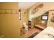 Bathroom with tiled floors, double sinks, decorative wall art, and a convenient bench at 4163 Otterbein Ave, Indianapolis, IN 46227
