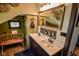 Inviting bathroom with double sink vanity, stylish mirror, and a quaint bench at 4163 Otterbein Ave, Indianapolis, IN 46227