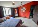 Bright bedroom with red accent wall, framed artwork and a plush white rug at 4163 Otterbein Ave, Indianapolis, IN 46227