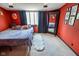 Bedroom featuring red walls, a full length mirror and a window with natural light at 4163 Otterbein Ave, Indianapolis, IN 46227