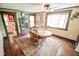 Bright dining room features a ceiling fan, unique table, and access to the bathroom at 4163 Otterbein Ave, Indianapolis, IN 46227