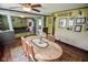 Open-concept dining room showcasing hardwood floors and access to the living room at 4163 Otterbein Ave, Indianapolis, IN 46227